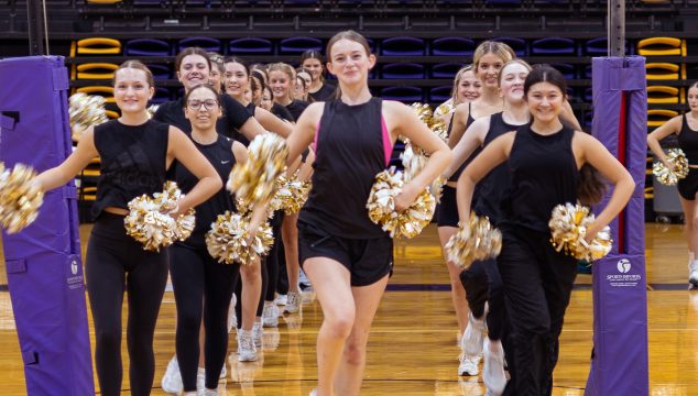 Thirty-six Belles stretch across the Wylie High School gym during practice. The 14th line is the largest in program history.