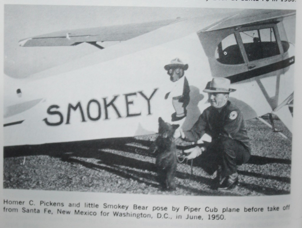 Homer Pickens and Smokey pose in front of the plane that flew him to Washington.