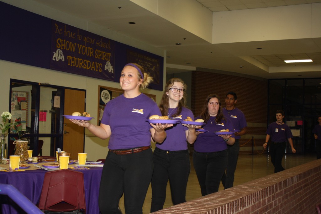 Students from the Wylie Pure Gold Band serve the meal during the foundation dinner.