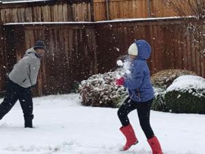 Timothy Varghese (8th grade) and Sarah Varghese (4th) having a snowball fight!
